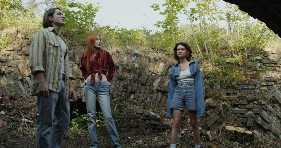 friends-are-standing-near-ruins-large - Iconic Hippie Trends