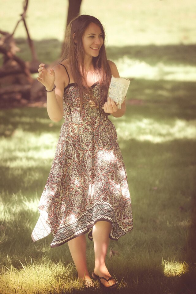full-length-woman-holding-camera-field-large_Iconic Hippie Fashion Trends